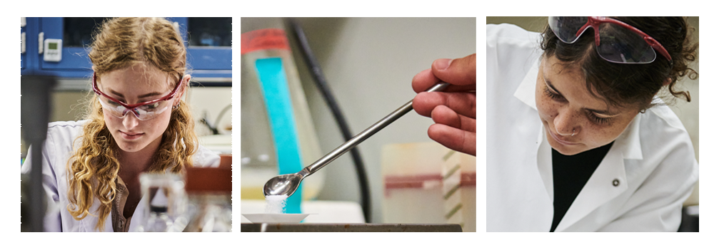 Image of two student researchers in the lab. One has curly brown hair and the other has curly red hair.